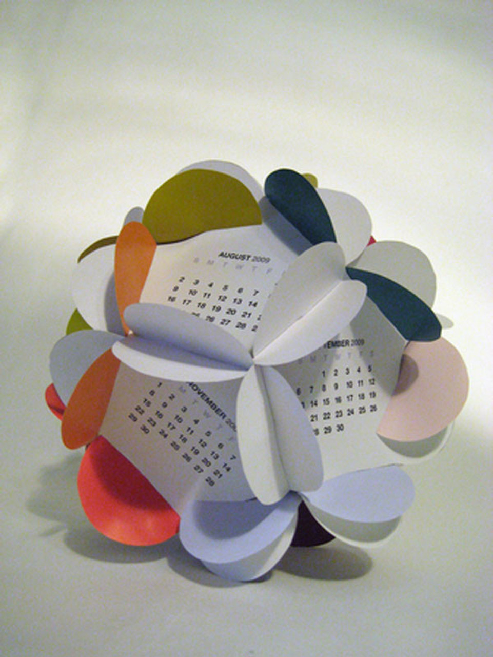 Birbirine geçirilen kağıtlarla oluşturulan top şeklindeki bir takvim örneği